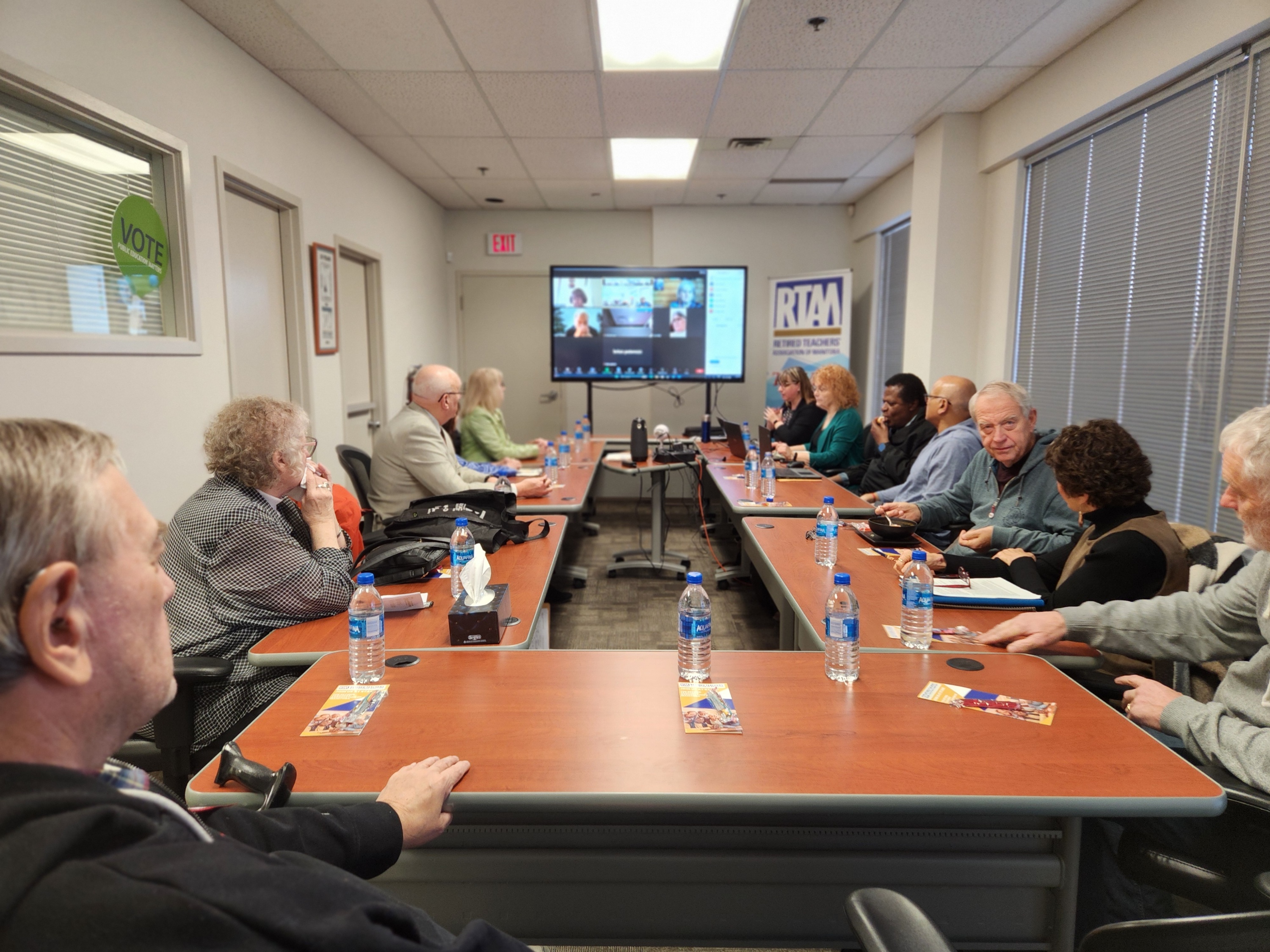 retired-teachers-sitting-at-conference-table