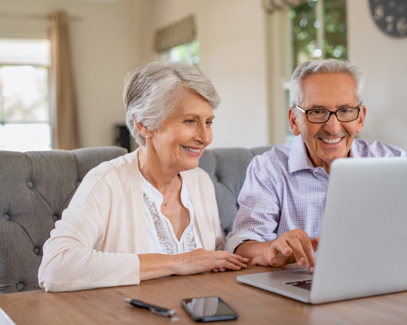 two-seniors-smile-on-computer